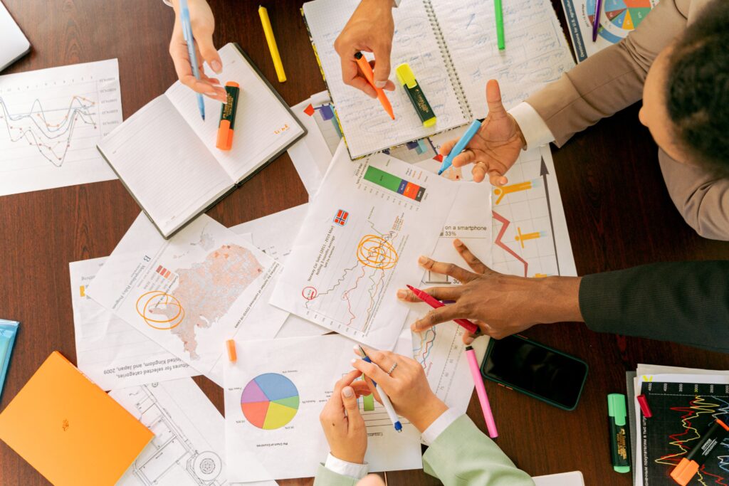 Business professionals collaborating over charts and data in a conference room.
